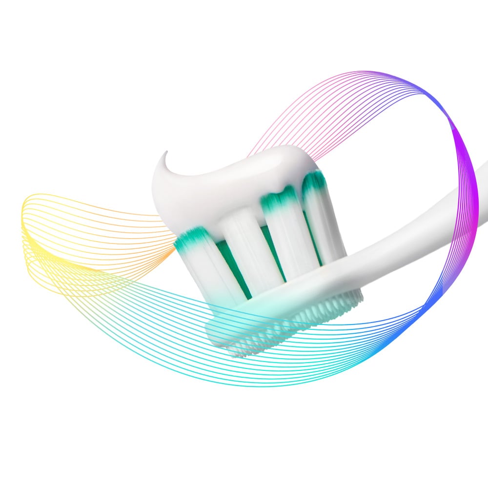 Kepala sikat gigi Colgate Total dengan pasta di atasnya, dikelilingi oleh sinar pencegahan warna-warni