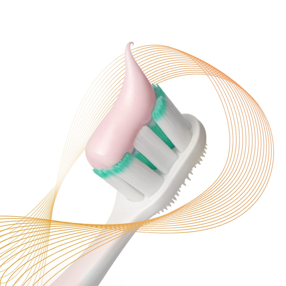 Kepala sikat gigi Colgate Total dengan pasta di atasnya, dikelilingi oleh sinar pencegahan warna-warni